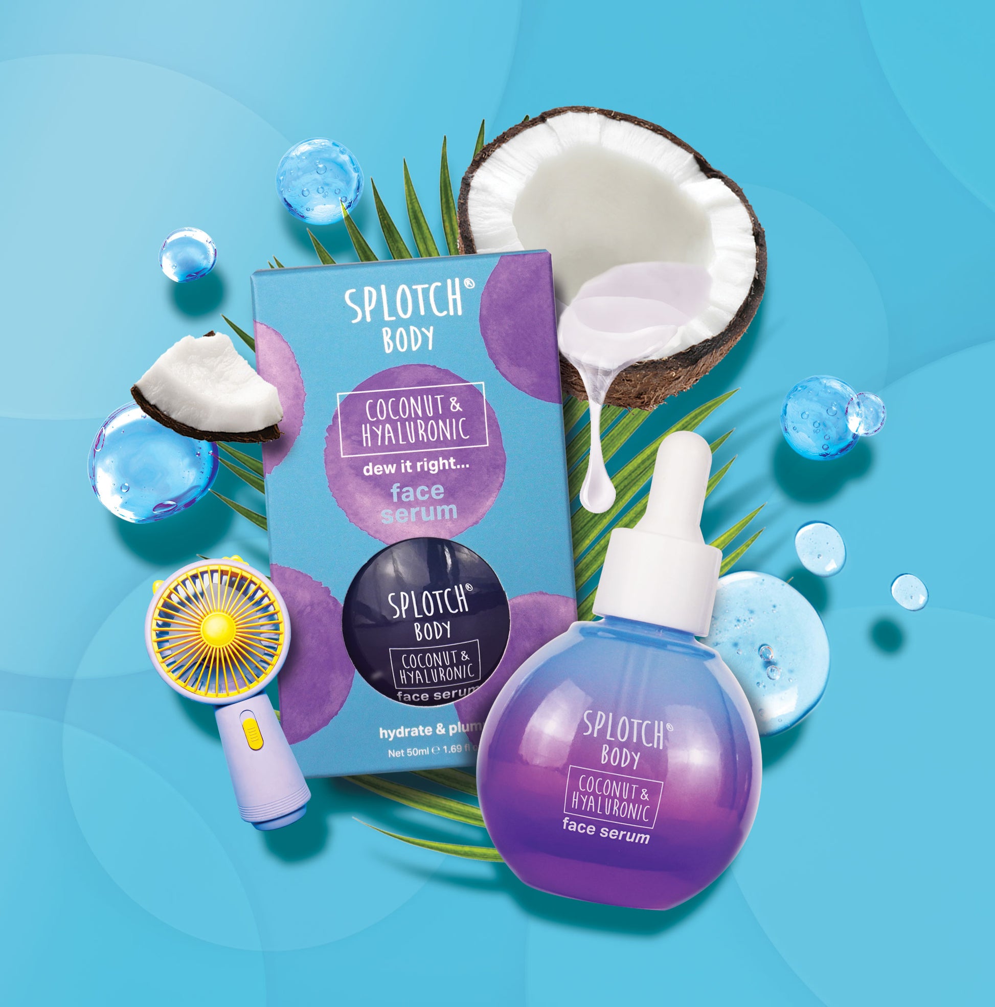 A still-life product image of SPLOTCH BODY Coconut & Hyaluronic Face Serum. The serum is shown in a small, round, purple-to-blue gradient bottle with a white dropper cap, next to its light blue box with purple splotches. The box reads "dew it right... face serum" and "hydrate & plump." A half coconut, a coconut chunk, water droplets, a green palm leaf, and a small yellow-and-lavender handheld fan are scattered around the products on a bright blue background.