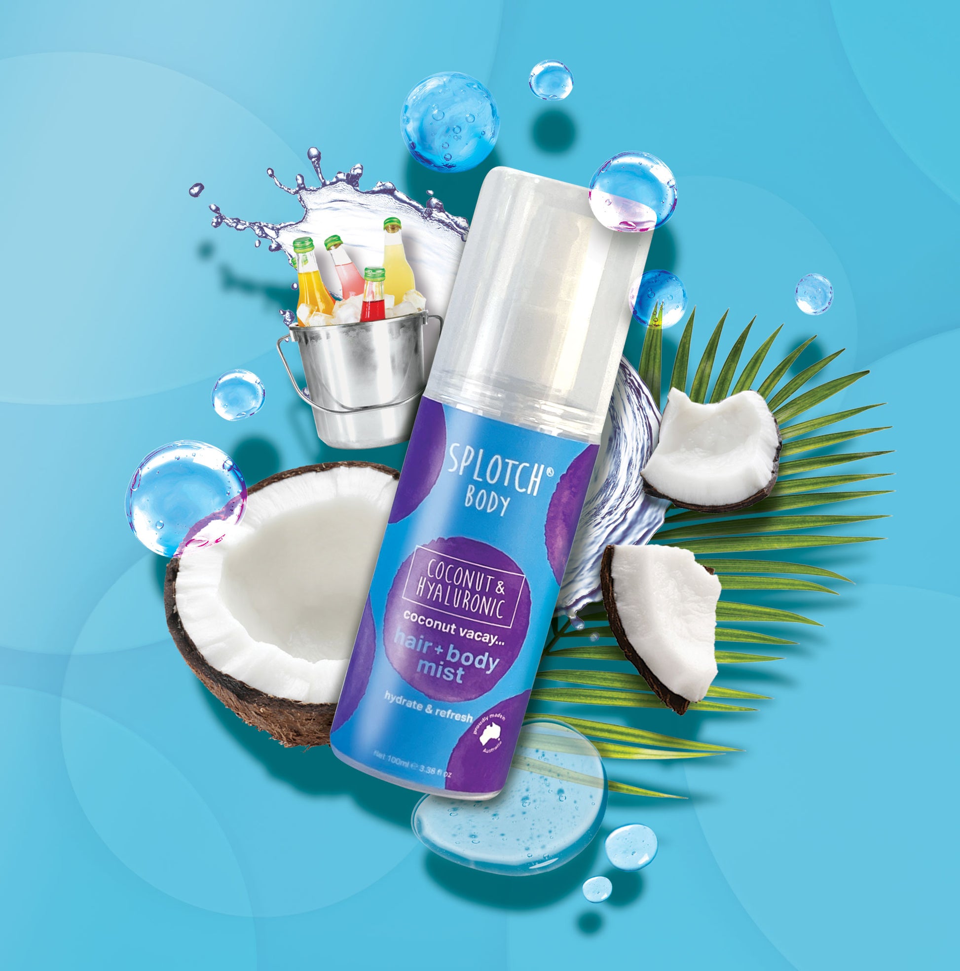 A product shot of the SPLOTCH BODY Coconut & Hyaluronic hair + body mist on a bright blue background. The spray bottle reads "coconut vacay... hair + body mist" and "hydrate & refresh." It is surrounded by water bubbles, cut coconuts, a palm leaf, and a small metal bucket holding colorful bottled drinks.