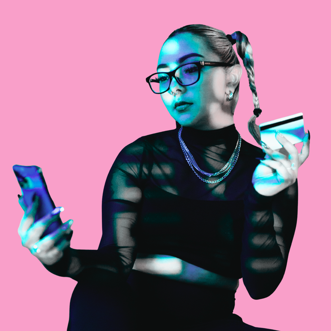A woman with a braided ponytail and glasses is shown in high-contrast blue and black tones against a solid pink background, holding a smartphone in one hand and a credit card in the other.